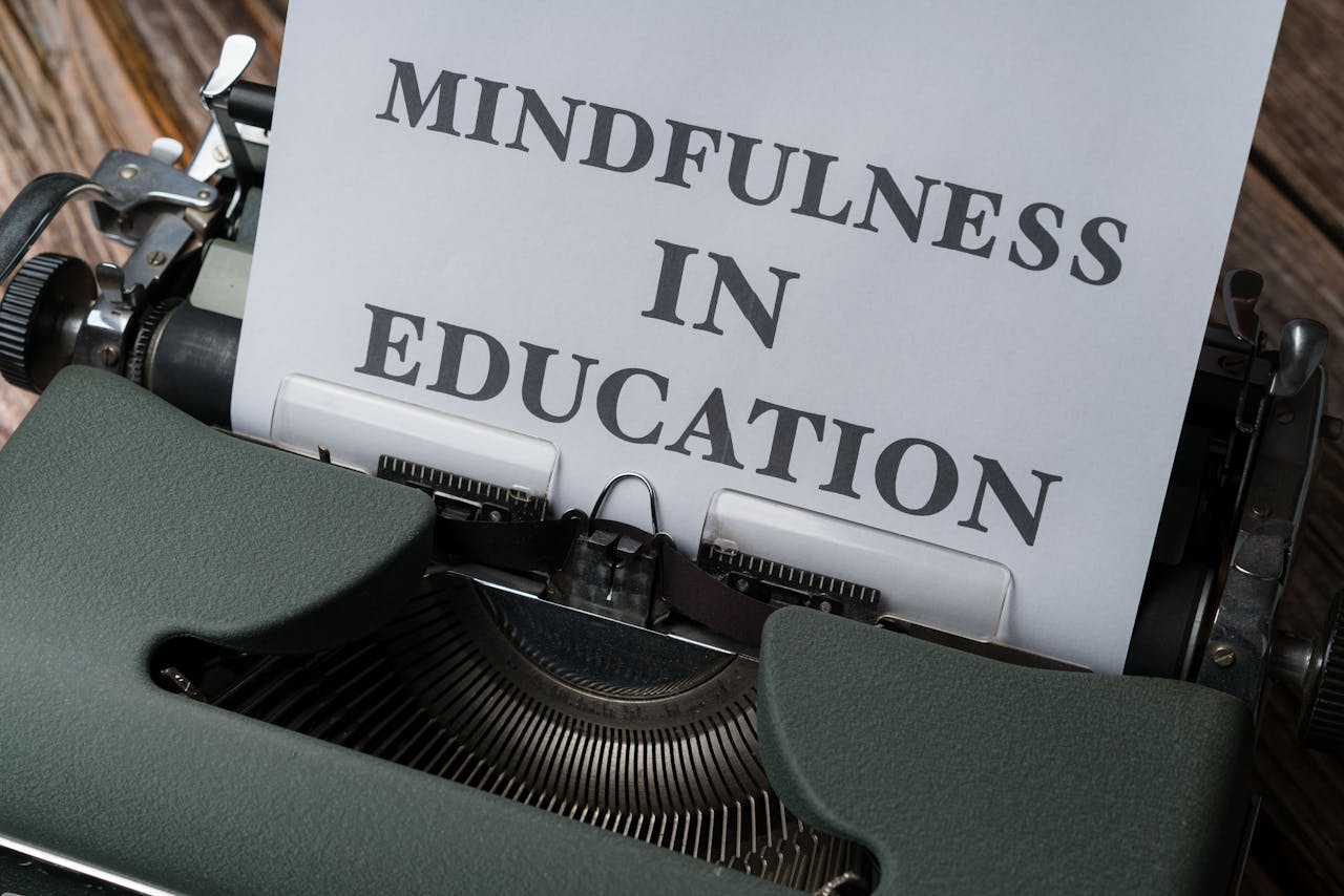 Close-up of a vintage typewriter with 'Mindfulness in Education' paper.
