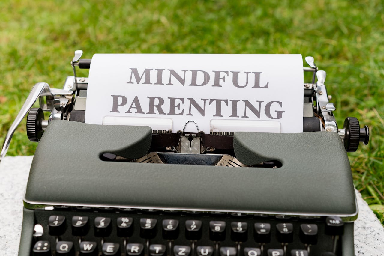 Close-up of a typewriter with 'Mindful Parenting' text, outdoors.